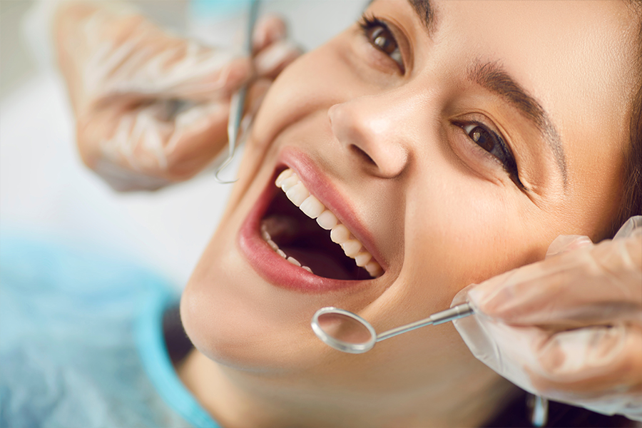 Dentist examining patient at Pristine Maxillofacial & Dental